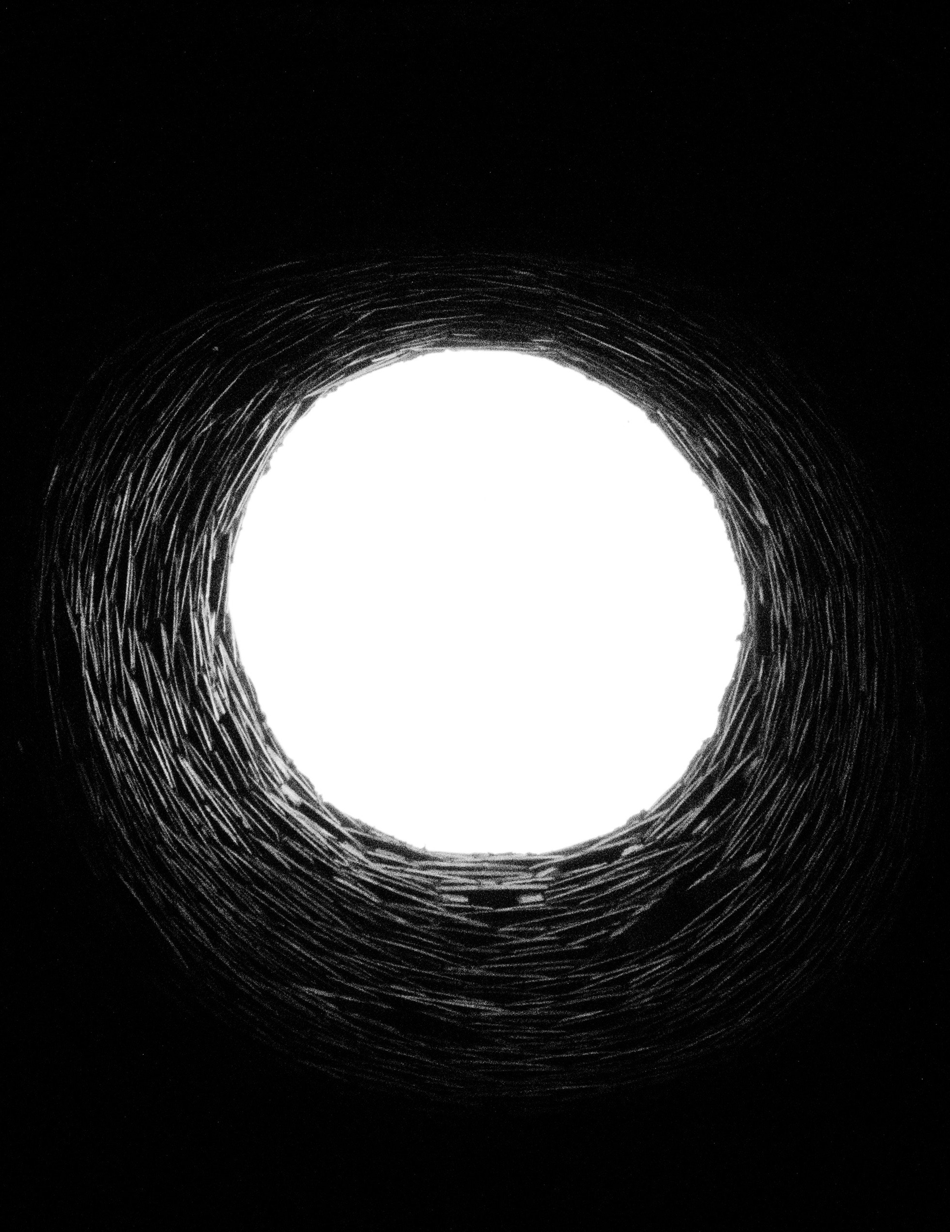 A round opening in a well, showing a bright sky