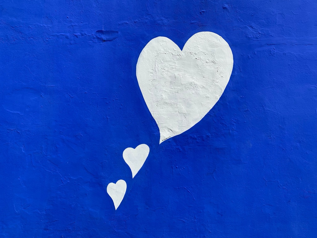 A blue background with white hearts.